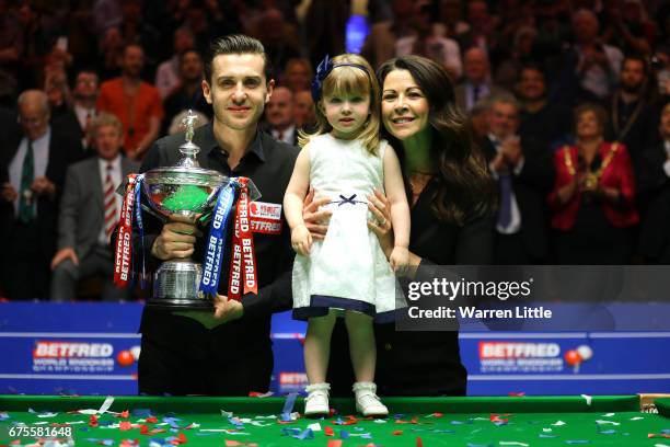 Mark Selby of England poses with the trophy with his duaghter Sofia and wife Vikki after beating John Higgins of Scotland in the final of the World...