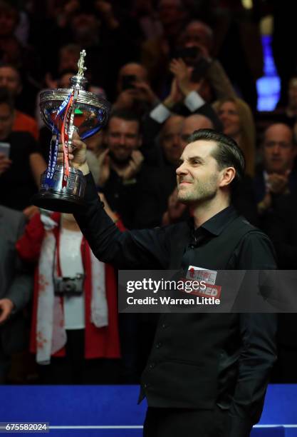 Mark Selby of England poses with the trophy after beating John Higgins of Scotland in the final of the World Snooker Championship on day seventeen at...