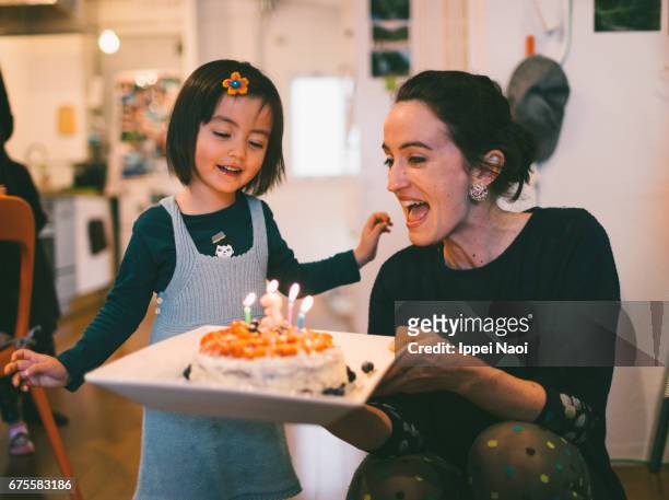 Cute toddler girl showing excitement with her birthday cake