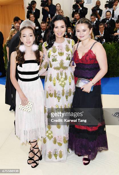 Wendi Deng Murdoch with her daughters Chloe Murdoch and Grace Helen Murdoch attends "Rei Kawakubo/Comme des Garcons: Art Of The In-Between" Costume...