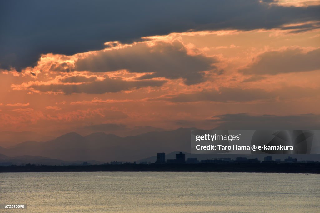 Jacob's ladder on the sunset beach, town and mountains