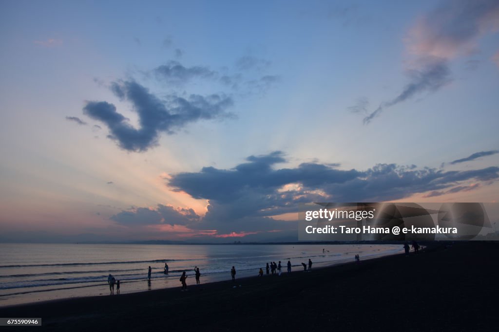 Jacob's ladder and people on the sunset beach