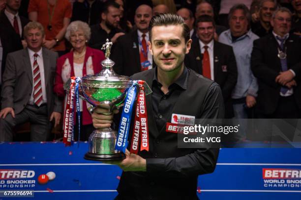 Mark Selby of England poses with his trophy after winning the final match against John Higgins of Scotland on day seventeen of Betfred World...