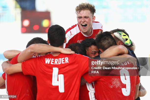 Switzerland players including Dejan Stankovic, Glenn Hodel, Nicola Werder and Mo Jaeggy celebrate victory in the penalty shoot-out during the FIFA...