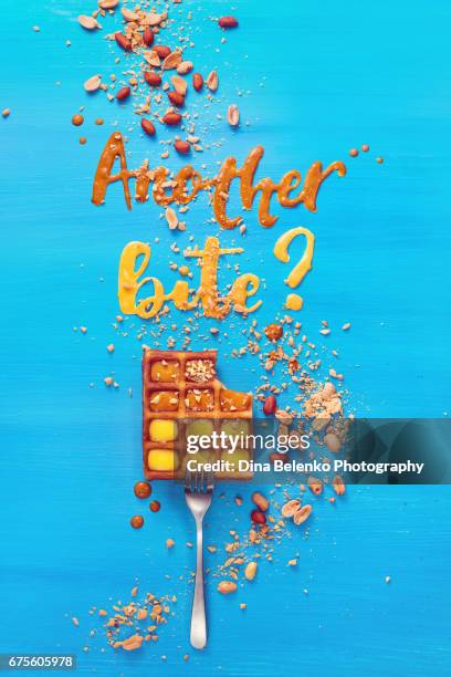 belgian waffle on a fork with lettering on a sky blue background - peanut food - fotografias e filmes do acervo