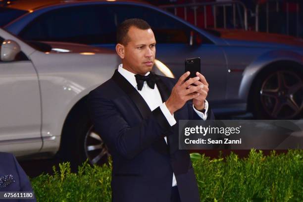 Alex Rodriguez taking a shot of Jennifer Lopez on the red carpet of the "Rei Kawakubo/Comme des Garcons: Art Of The In-Between" Costume Institute...