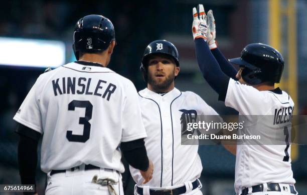 Tyler Collins of the Detroit Tigers celebrates with Ian Kinsler of the Detroit Tigers and Jose Iglesias of the Detroit Tigers after hitting a...