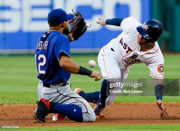 Jose Altuve of the Houston Astros reaches second base after an error by left fielder Nomar Mazara as Rougned Odor is unable to handle the throw in...