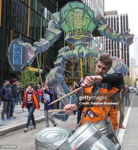 Drummer takes part in a protest in front of a Amazon.com CEO Jeff Bezos effigy outside of the Amazon.com headquarters on May 1, 2017 in Seattle,...