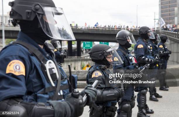Washington State troopers block access to Interstate 5 as Workers and Immigrant Rights March participants pass by on May 1, 2017 in Seattle,...