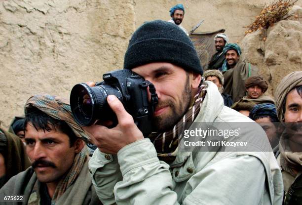 Getty Images photographer Oleg Nikishin takes pictures November, 30 2001 at a Northern Alliance base near Mazar-i-Sharif, Afghanistan.