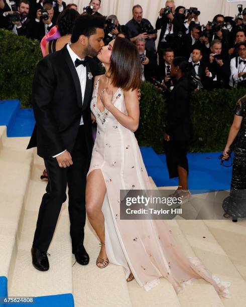 The Weeknd kisses Selena Gomez at "Rei Kawakubo/Commes Des Garcons: Art of the In-Between", the 2017 Costume Institute Benefit at Metropolitan Museum...