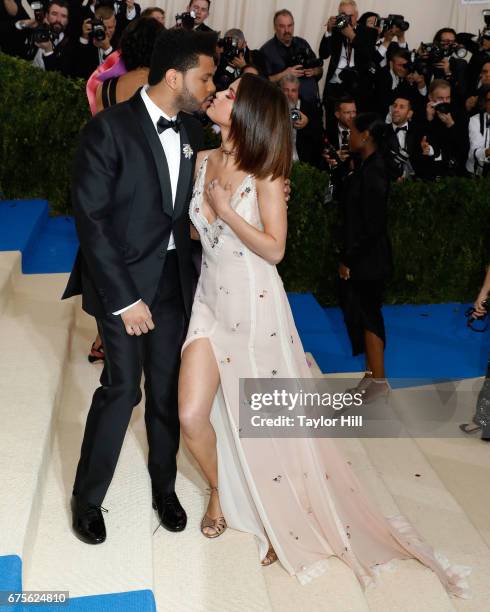 The Weeknd kisses Selena Gomez at "Rei Kawakubo/Commes Des Garcons: Art of the In-Between", the 2017 Costume Institute Benefit at Metropolitan Museum...