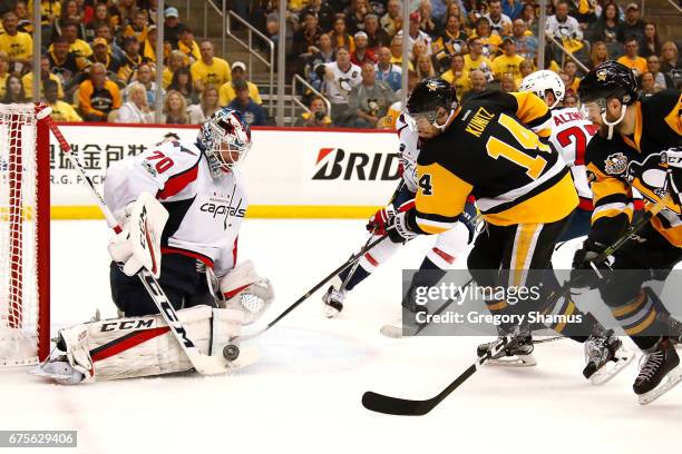 Braden Holtby of the Washington Capitals makes a second period save on Chris Kunitz of the Pittsburgh Penguins in Game Three of the Eastern...