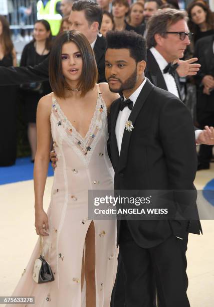 Selena Gomez and The Weeknd arrive for the Costume Institute Benefit on May 1 at the Metropolitan Museum of Art in New York. / AFP PHOTO / ANGELA...