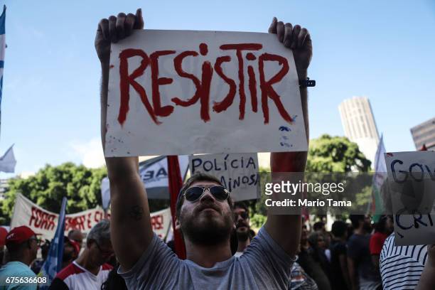 Demonstrators protest against the government's proposed pension reforms and other austerity measures on May 1, 2017 in Rio de Janeiro, Brazil....