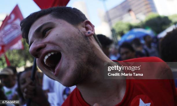 Demonstrators protest against the government's proposed pension reforms and other austerity measures on May Day on May 1, 2017 in Rio de Janeiro,...