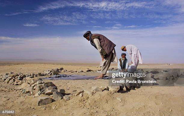 Afghan refugees at Roghani refugee camp pray during Ramadan December 4, 2001 near Chaman, Pakistan on the Afghanistan border. The UNHCR estimates...