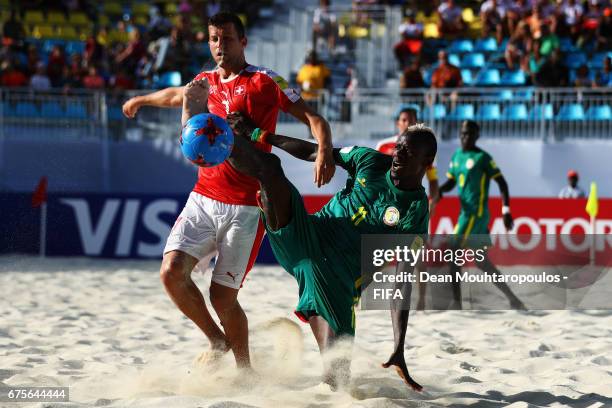 Ibrahima Balde of Senegal battles for the ball with Sandro Spaccarotella of Switzerland during the FIFA Beach Soccer World Cup Bahamas 2017 group A...