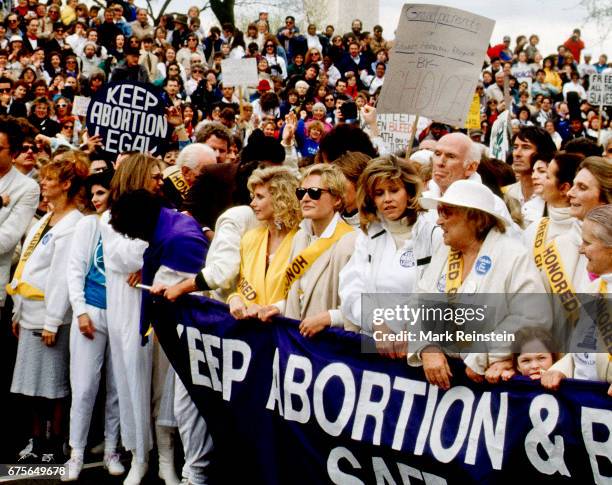 View of celebrity and civilian activists as they stand behind a 'Keep Abortion & Birth Control Safe and Legal' banner during the March for Women's...