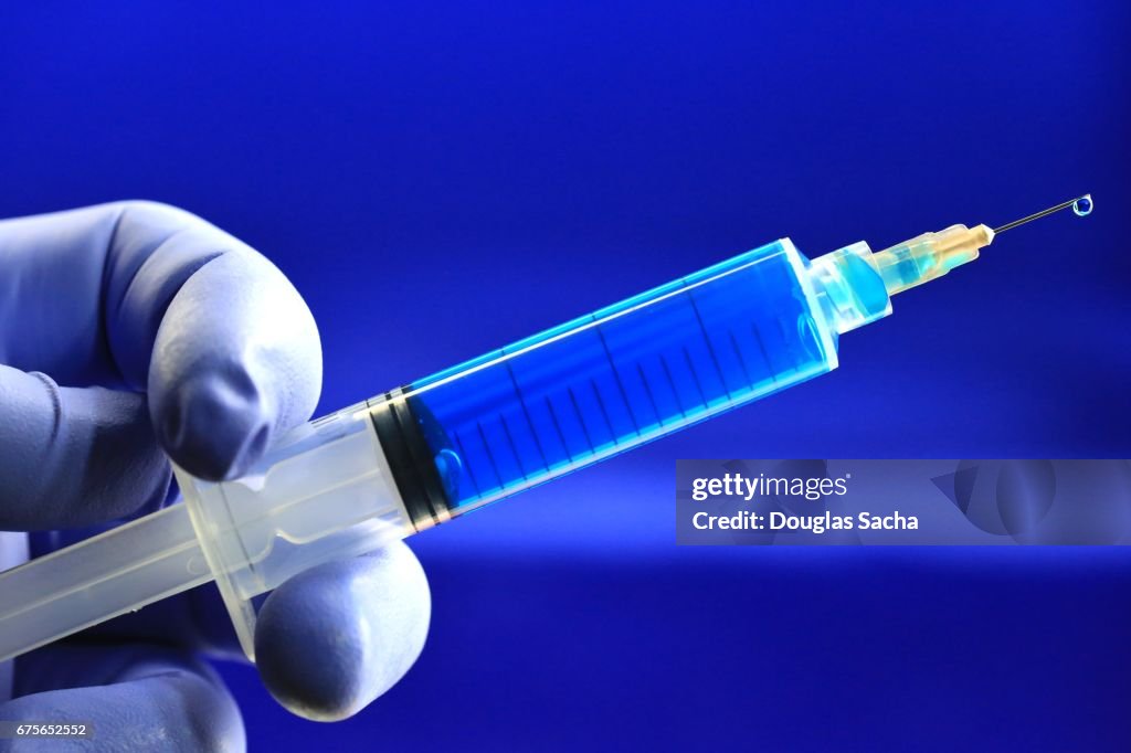 Blue colored vaccine on a blue background
