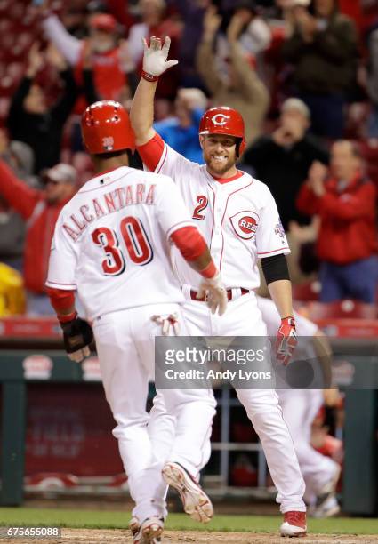 Zack Cozart of the Cincinnati Reds celbrates as Arismendy Alcantara scores the game winning run in the 4-3 10th inning win over the Pittsburgh...
