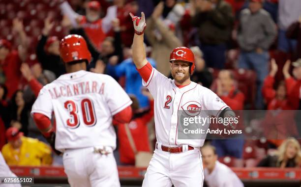 Zack Cozart of the Cincinnati Reds celbrates as Arismendy Alcantara scores the game winning run in the 4-3 10th inning win over the Pittsburgh...