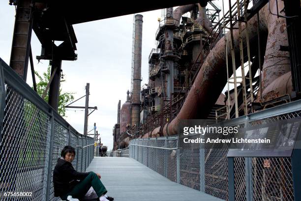 Chinese and Korean immigrants linger around Bethlehem Steel's closed factory on April 30, 2017 in Bethlehem, Pennsylvania. Taking advantage of free...