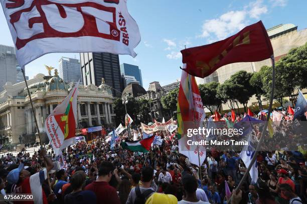 Demonstrators protest against the government's proposed pension reforms and other austerity measures on May Day on May 1, 2017 in Rio de Janeiro,...