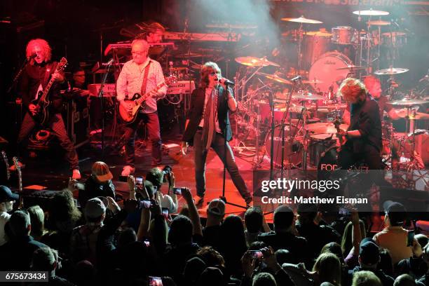 Musicians Bruce Watson, Mick Jones, Mike Bluestein, Kelly Hansen, Jeff Pilson and Chris Frazier of the band Foreigner perform live on stage during...