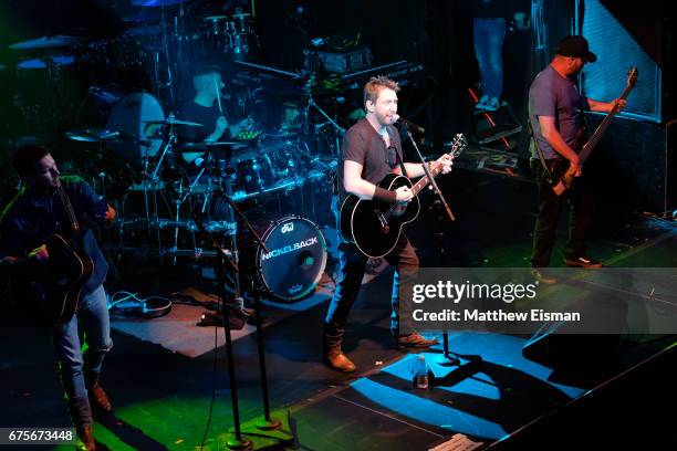 Musicians Ryan Peake, Daniel Adair, Chad Kroeger and Mike Kroeger of the band Nickelback perform live on stage during Live Nation's celebration of...