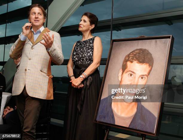 Artist Bradley McCallum unveils a portrait of journalist James Foley at the 2017 James W. Foley Freedom Awards at the Newseum on May 1, 2017 in...