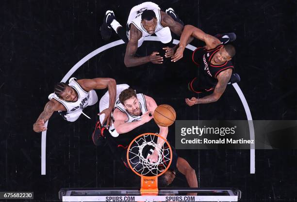 Pau Gasol of the San Antonio Spurs goes for a rebound against Nene Hilario of the Houston Rockets during Game One of the NBA Western Conference...