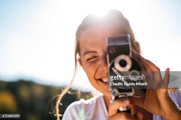 woman filming with old camera. - camera woman stock-fotos und bilder