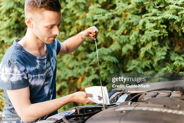 man checking oil status. - hood clothing stock pictures, royalty-free photos & images