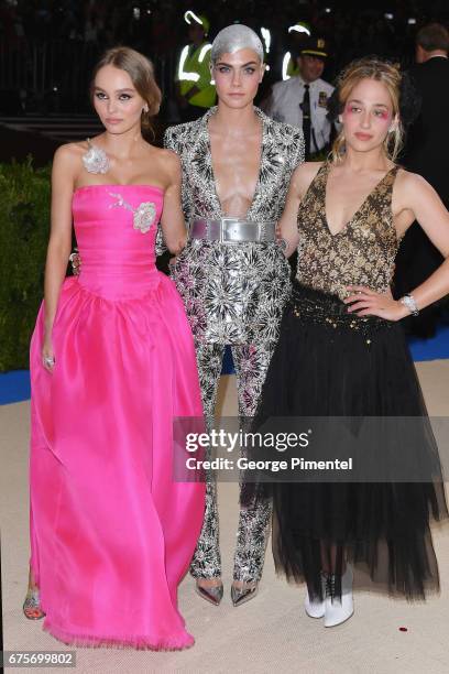 Lily-Rose Depp, Cara Delevingne and Jemima Kirke attend the "Rei Kawakubo/Comme des Garcons: Art Of The In-Between" Costume Institute Gala at...