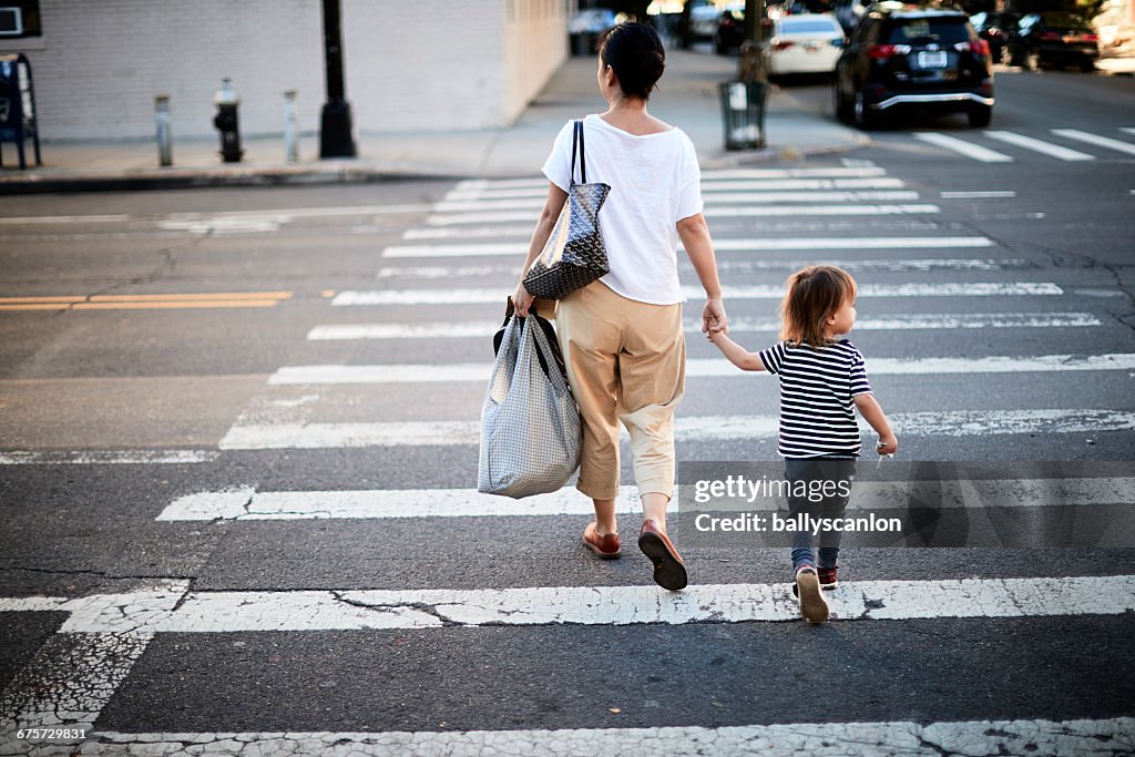 Mother And Son Walking Across Street.