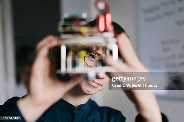 teenager admiring homemade robot - innovacion fotografías e imágenes de stock