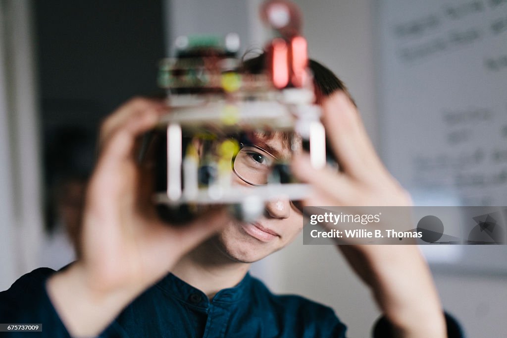 Teenager admiring homemade Robot