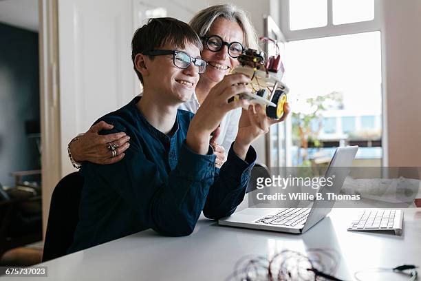 Mother and son with completed electronic project