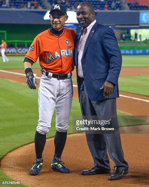 President of Baseball Operations Michael Hill with Ichiro Suzuki of the Miami Marlins for his 3000th hit honor before the game between the Miami...