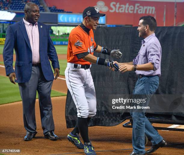 President of the Miami Marlins David P. Samson and President of Baseball Operations Michael Hill honor Ichiro Suzuki of the Miami Marlins for his...