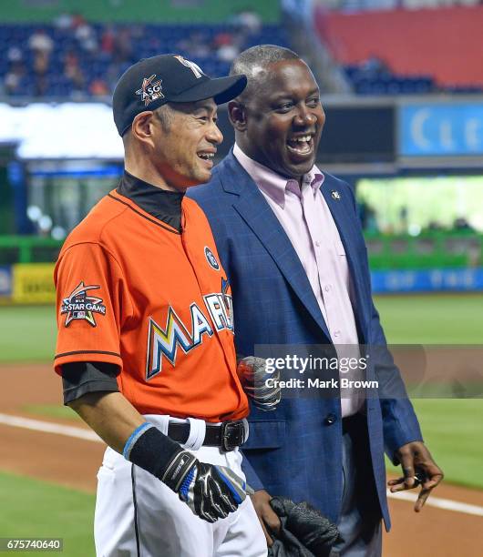 President of Baseball Operations Michael Hill with Ichiro Suzuki of the Miami Marlins for his 3000th hit honor before the game between the Miami...