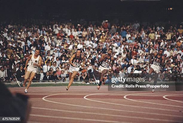 American track and field athlete Tommie Smith pictured far right in action competing for the United States team to finish first to win the gold...