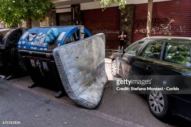 An abandoned mattress near the waste bins on the street in Torpignattara neighborhood on May 1, 2017 in Rome, Italy. Rome has suffered in recent...