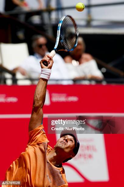 Russian player Evgeny Donskoy serves to Spanish tennis player Tommy Robredo during their Millennium Estoril Open ATP Singles 1st round tennis match,...