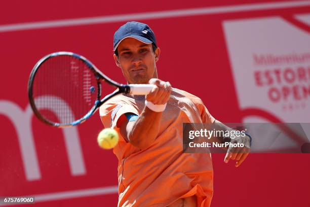 Russian player Evgeny Donskoy returns the ball to Spanish tennis player Tommy Robredo during their Millennium Estoril Open ATP Singles 1st round...