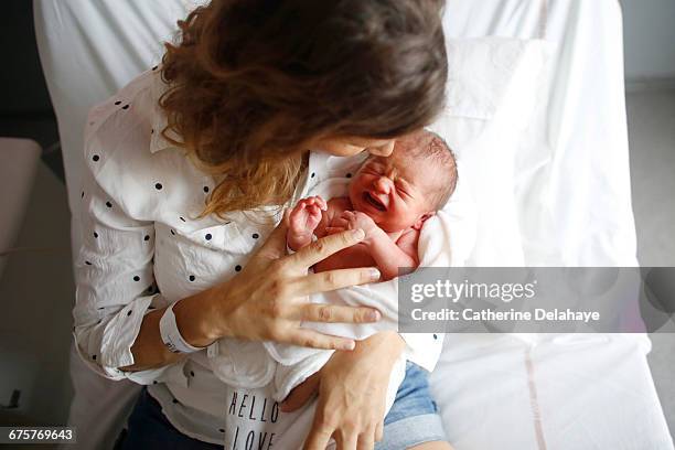 a newborn and his mother at maternity ward - moms crying in bed stock pictures, royalty-free photos & images