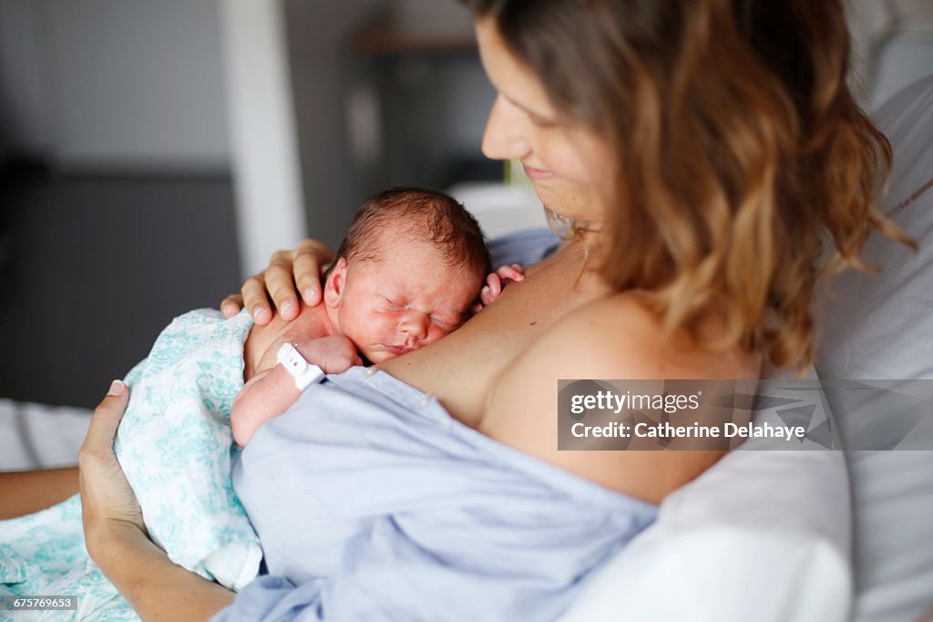 A newborn and his mother at maternity ward