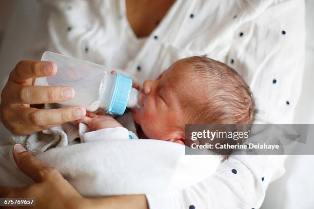 a newborn drinking milk at maternity ward - baby feeding fotografías e imágenes de stock